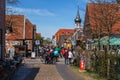 Crowded pedestrian zone in Hooksiel, Germany on a sunny spring day